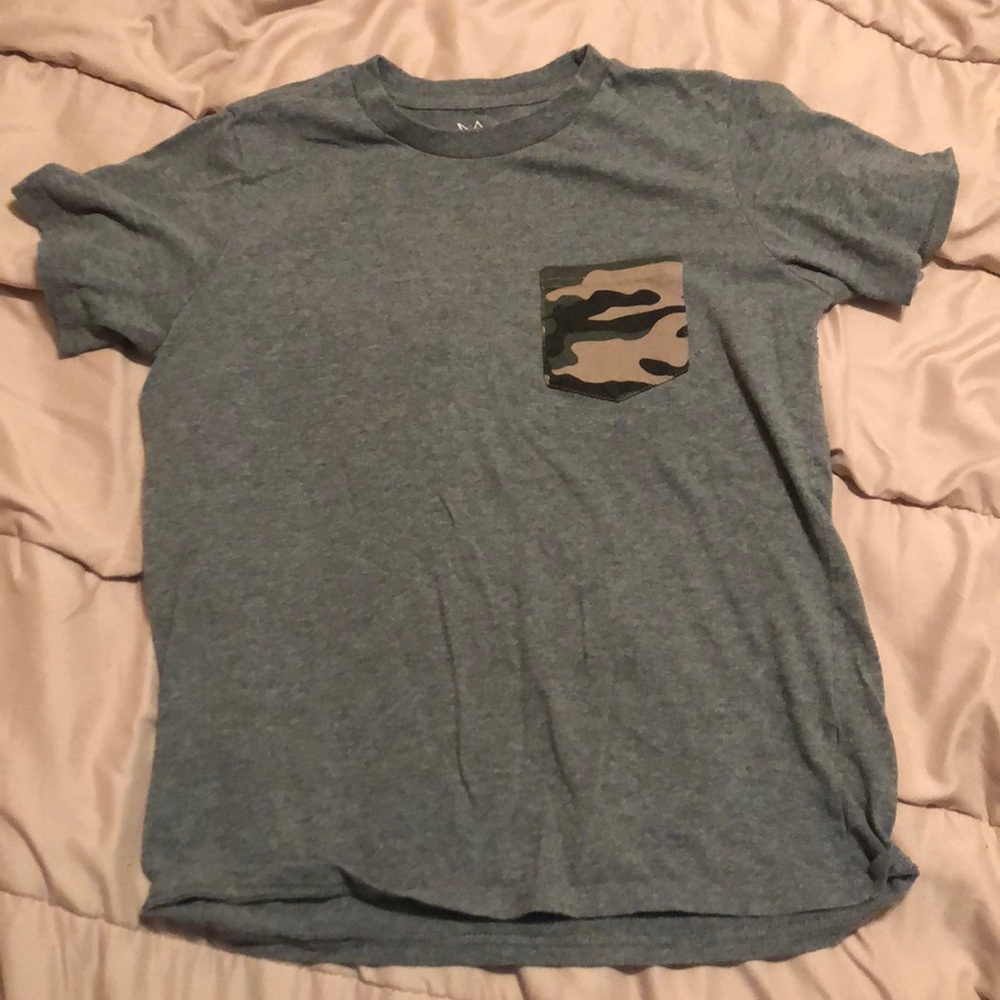 Gray shirt with camouflage poker with small hole.